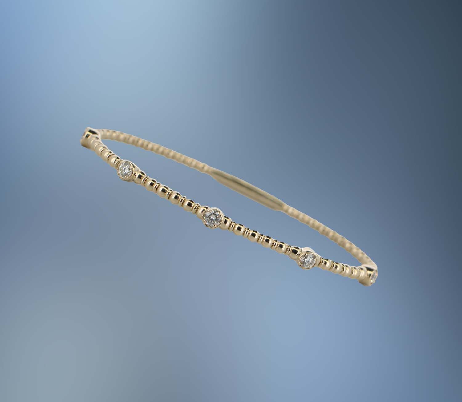 ONE 14KT YELLOW GOLD DIAMOND FLEXIBLE BANGLE