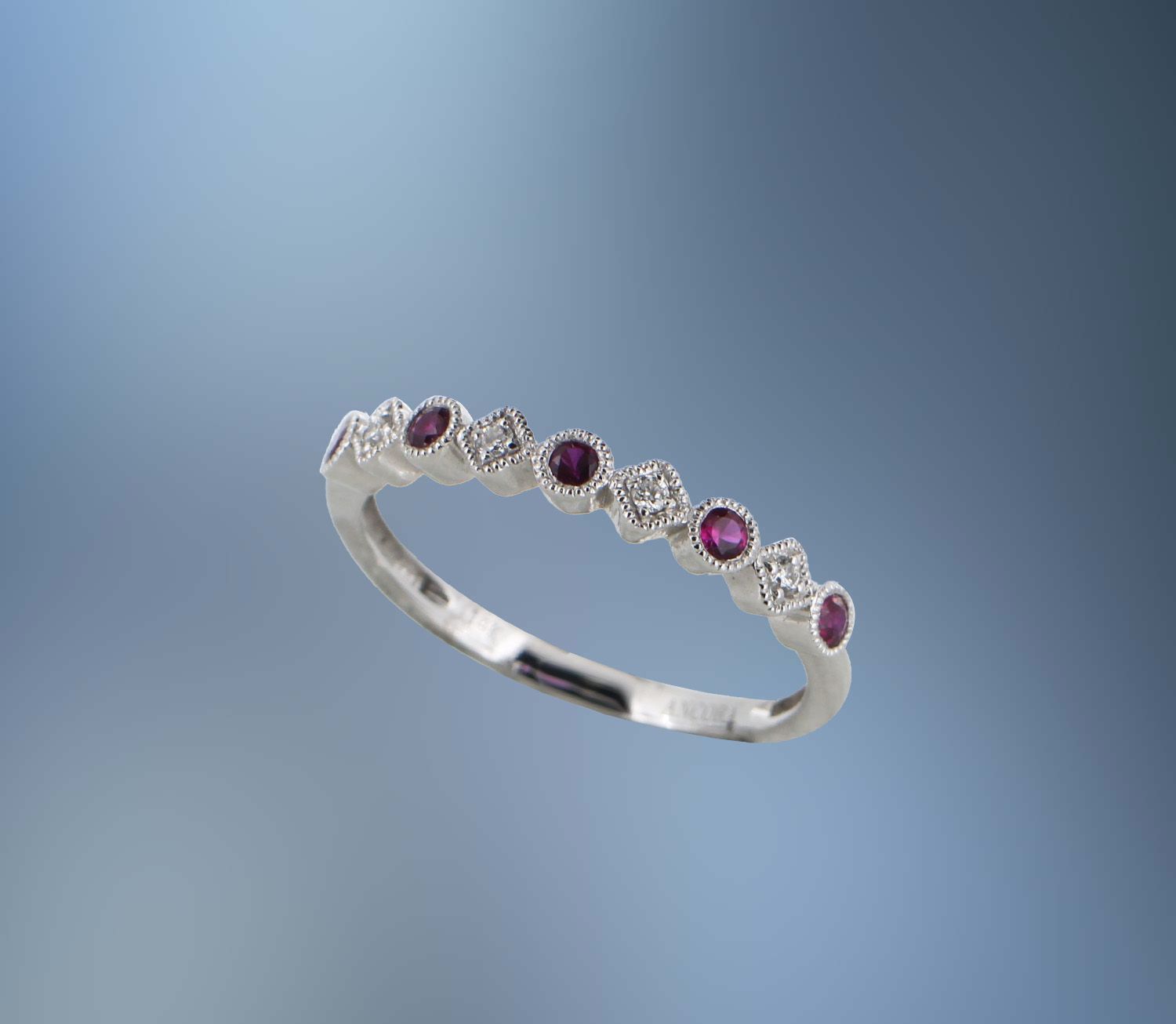 14K WHITE GOLD DIAMOND AND RUBY BAND FEATURING 5 ROUND RUBIES TOTALING 0.23 CTS AND 4 ROUND BRILLIANT CUT DIAMONDS TOTALING 0.05 CTS 14K WHITE GOLD DIAMOND AND RUBY BAND FEATURING 5 ROUND RUBIES TOTALING 0.23 CTS AND 4 ROUND BRILLIANT CUT DIAMONDS TOTALING 0.05 CTS