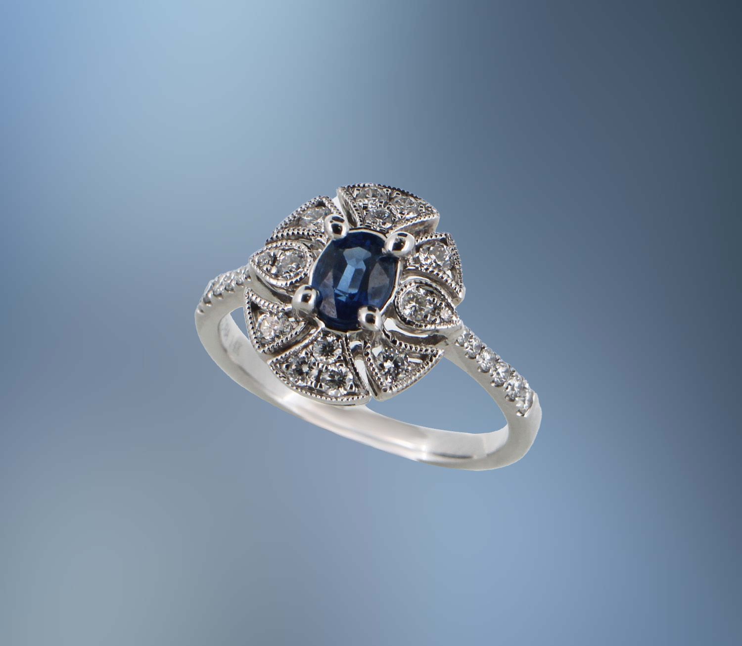 14KT WHITE GOLD SAPPHIRE RING FEATURING AN OVAL SAPPHIRE TOTALING 0.50 CTS AND 26 DIAMONDS TOTALING 0.45 CTS 14KT WHITE GOLD SAPPHIRE RING FEATURING AN OVAL SAPPHIRE TOTALING 0.50 CTS AND 26 DIAMONDS TOTALING 0.45 CTS