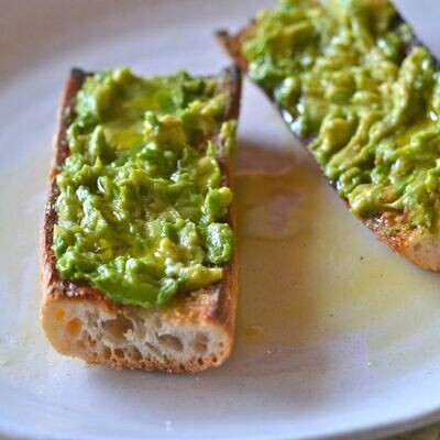 Avocado Toast - Two Slices of artisan bread with fresh avocado Avocado Toast - Two Slices of artisan bread with fresh avocado
