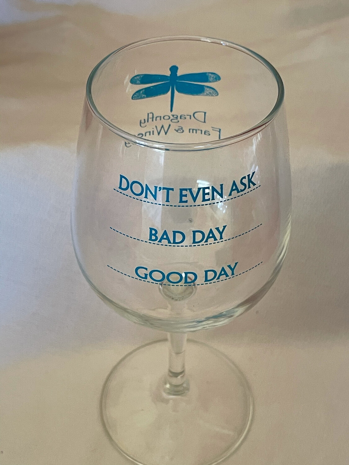 STEMMED WINE GLASS WITH TEAL DRAGONFLY LOGO AND GOOD DAY, BAD DAY, DON&#39;T ASK GAUGE