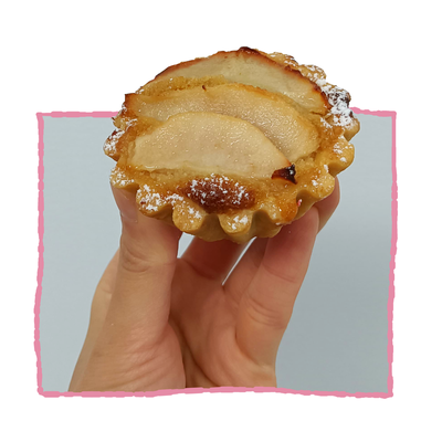amandine tart with a caramel coloured frangipane filling with sliced pears on top