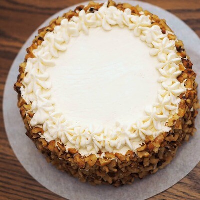 Vegan carrot cake with cream cheese frosting and roasted walnuts. GLUTEN FREE available.