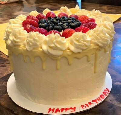 Tres Leches with cool whip icing, fresh fruits and white chocolate drip