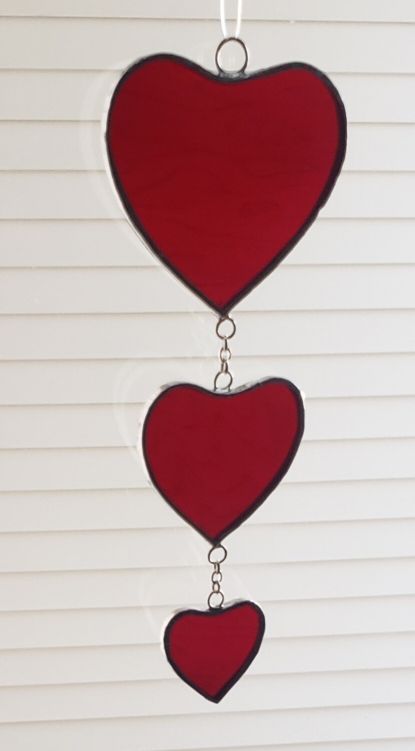 Three red hearts on a chain suncatcher