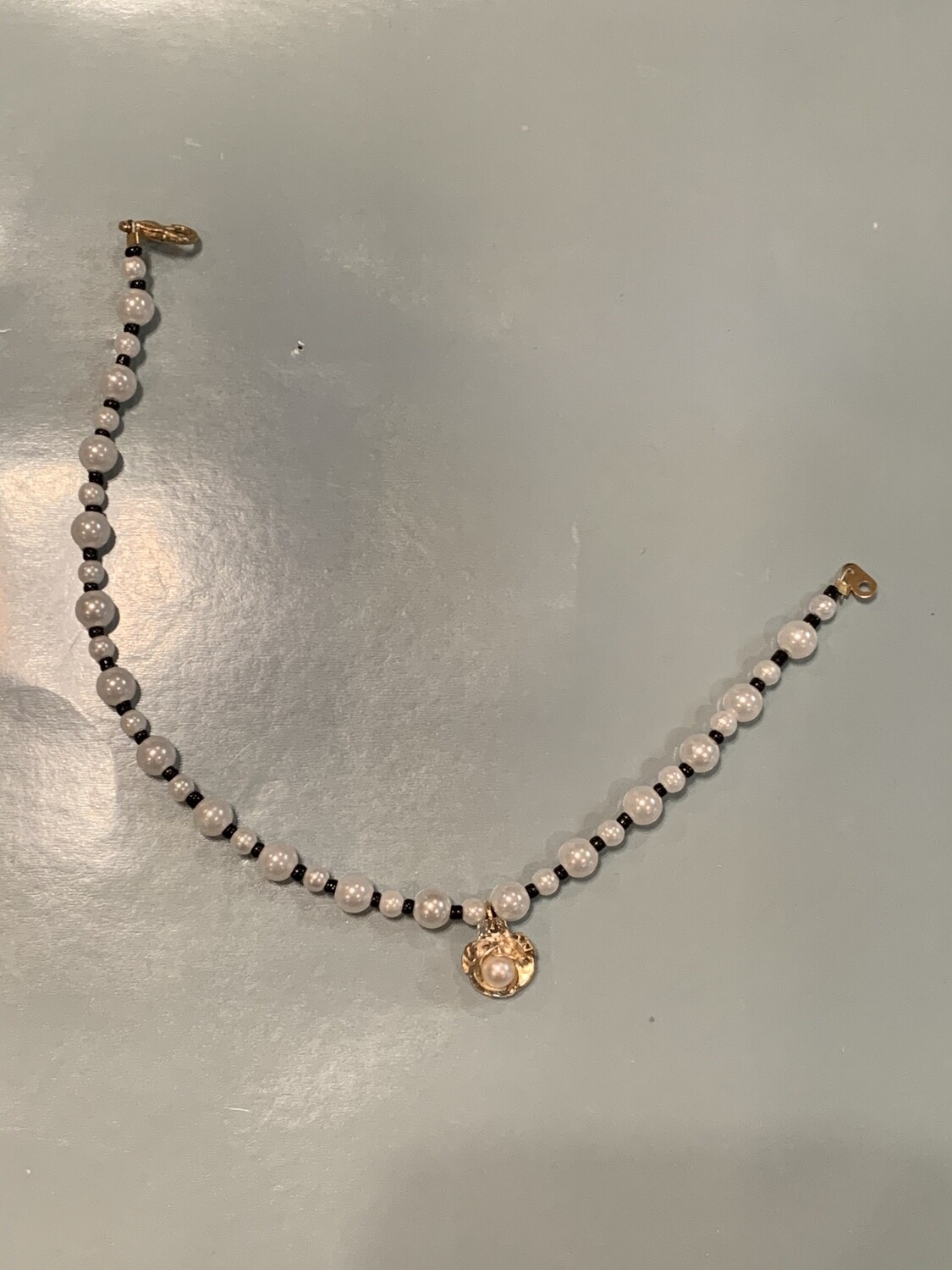 Black and white pearl anklet with gold flower charm