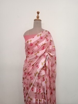 peach colour satin Georgette saree with floral pattern enrichment, paired with peach colour blouse