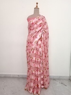 peach colour satin Georgette saree with floral pattern enrichment, paired with peach colour blouse