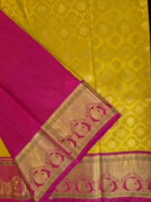Vibrant Yellow and Pink Kanjivaram Silk Saree with Gold Zari Border.