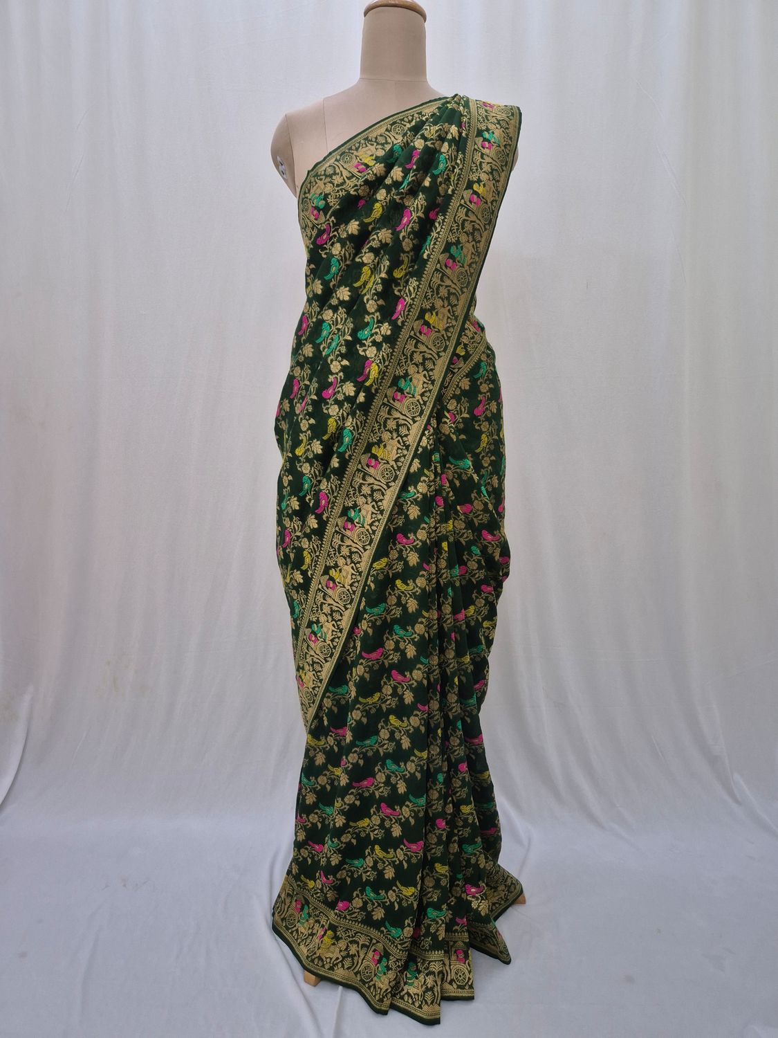 Elegant Green Silk Saree with Intricate Floral and Bird Motifs.