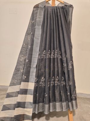 
Handwoven Black Cotton Saree with Traditional Tribal Motifs.