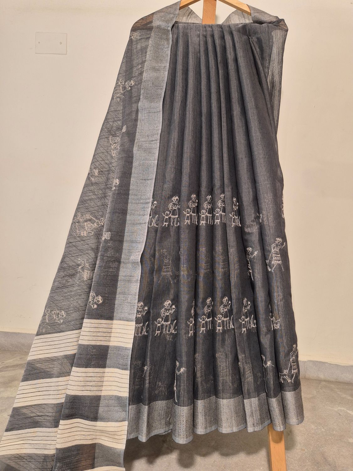 
Handwoven Black Cotton Saree with Traditional Tribal Motifs.