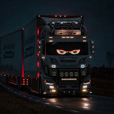 Truck with red and white LED eyes display mounted inside windscreen at night, creating glowing custom vehicle lighting effect