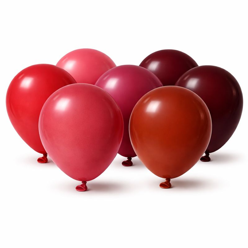 Six red balloons in varying shades arranged together on a white background showing colour range for balloon garlands