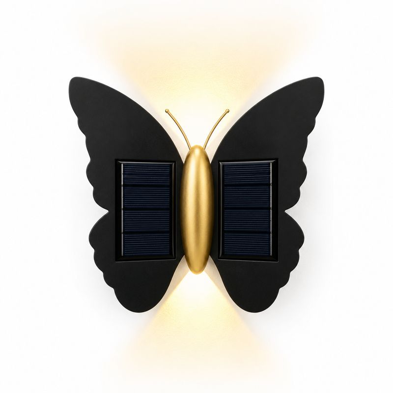 Butterfly solar wall light with warm up and down glow, black wings with solar panels and gold body on white background