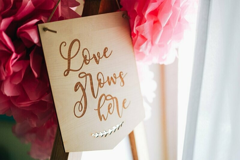 Wooden Love Grows Here sign