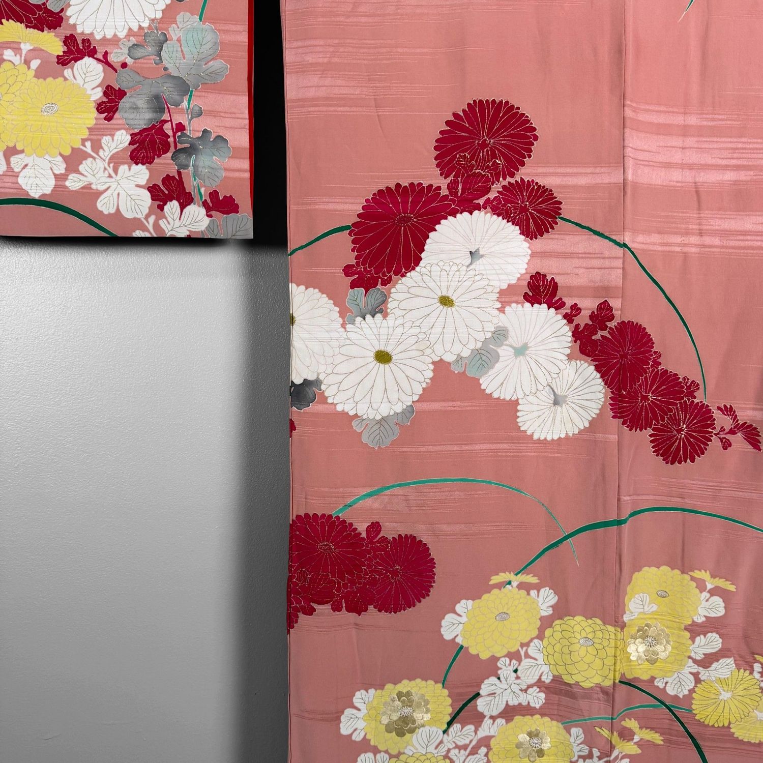 Salmon-pink Japanese silk kimono with chrysanthemums and embroidered accents, 1950s.