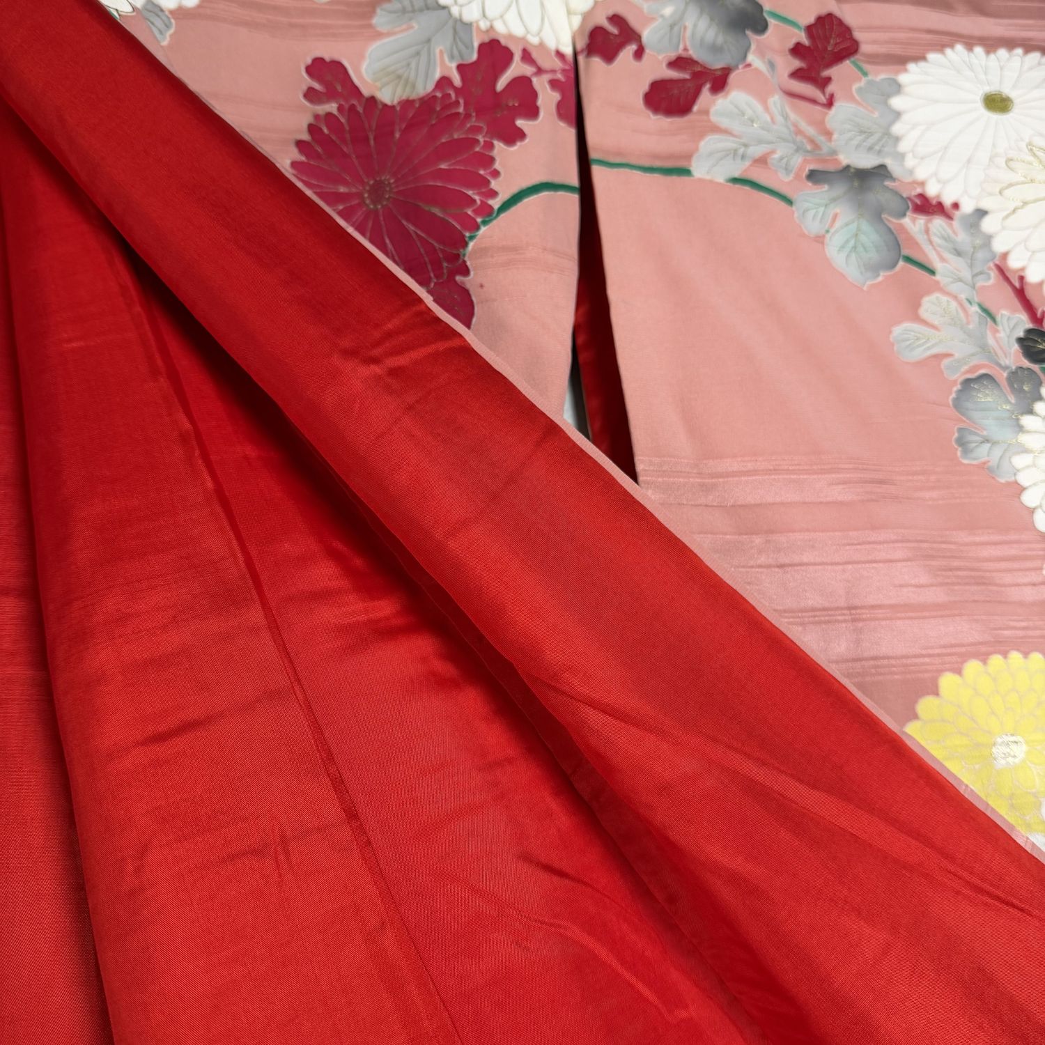 Salmon-pink Japanese silk kimono with chrysanthemums and embroidered accents, 1950s.
