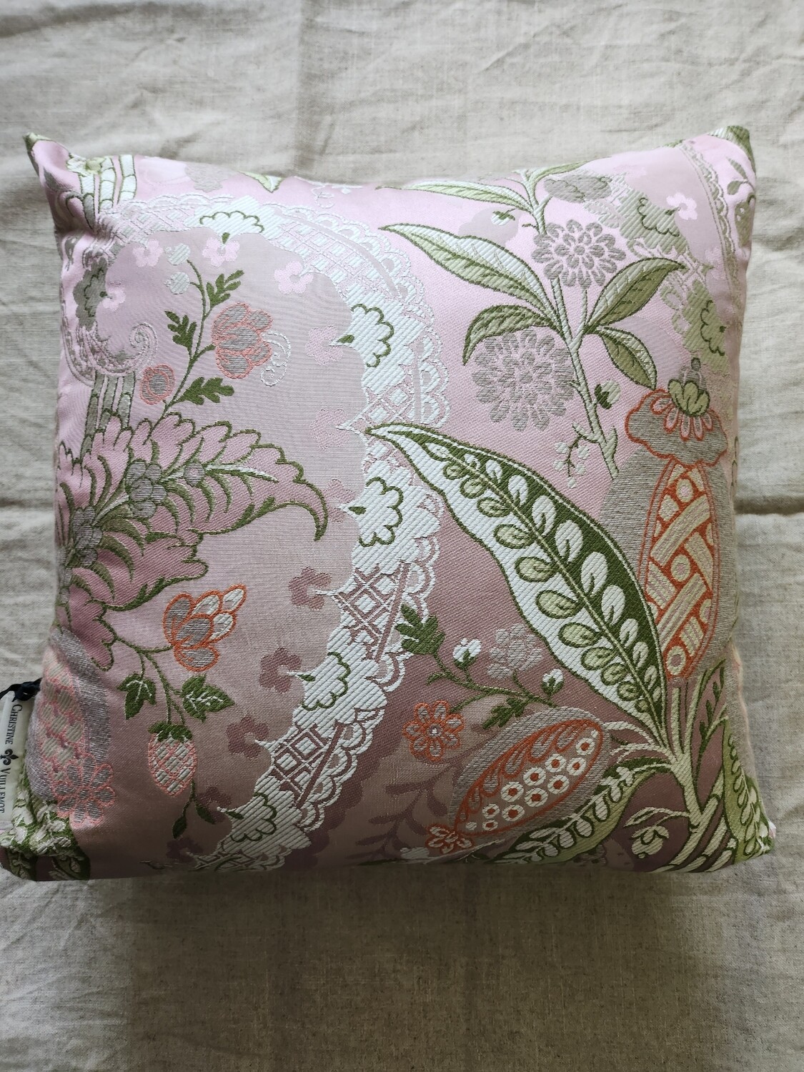 Multi colored silk lampas pillow, mostly pale pinks, green and silver.
