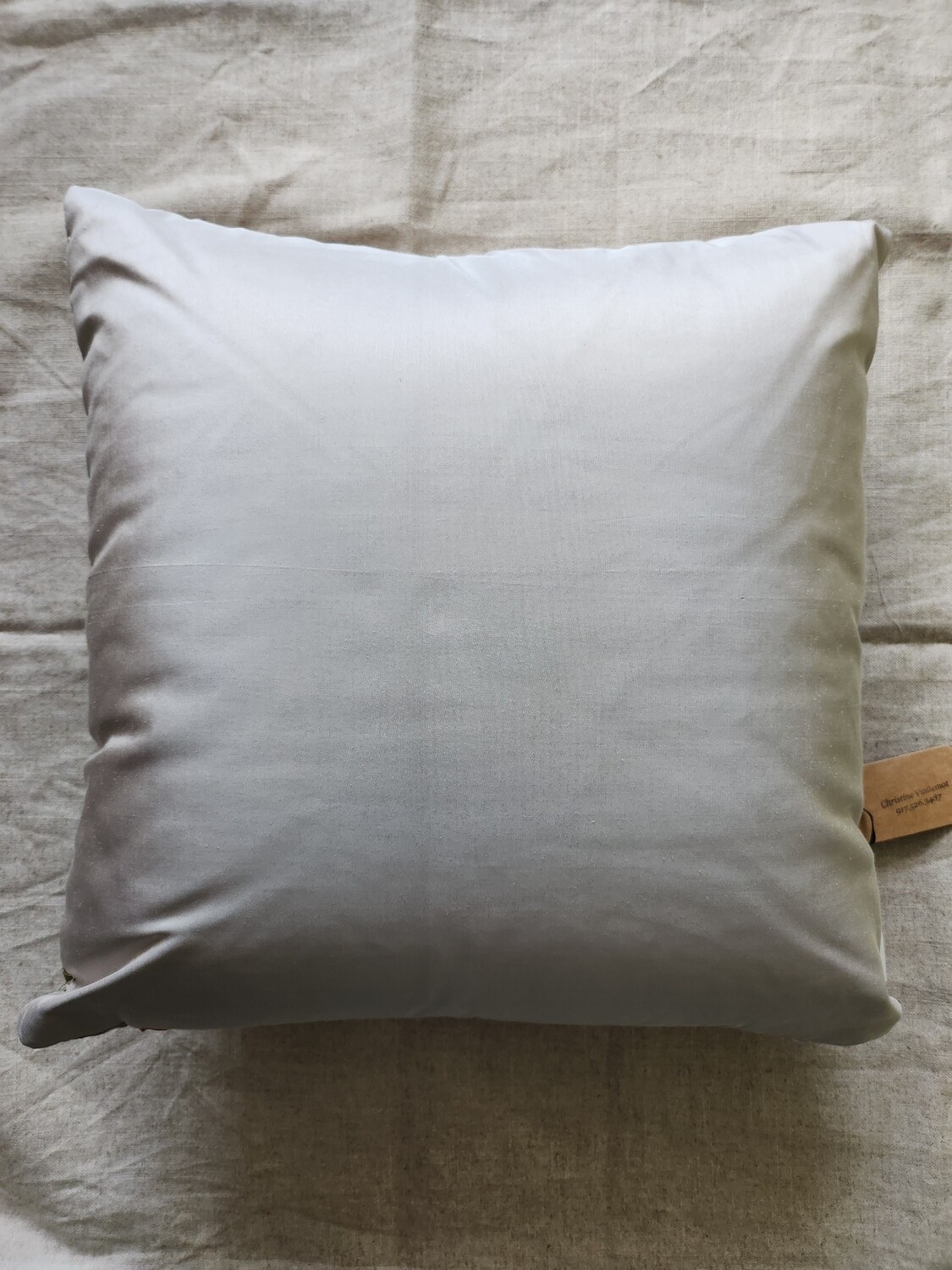 Multi colored silk lampas pillow, mostly pale pinks, green and silver.