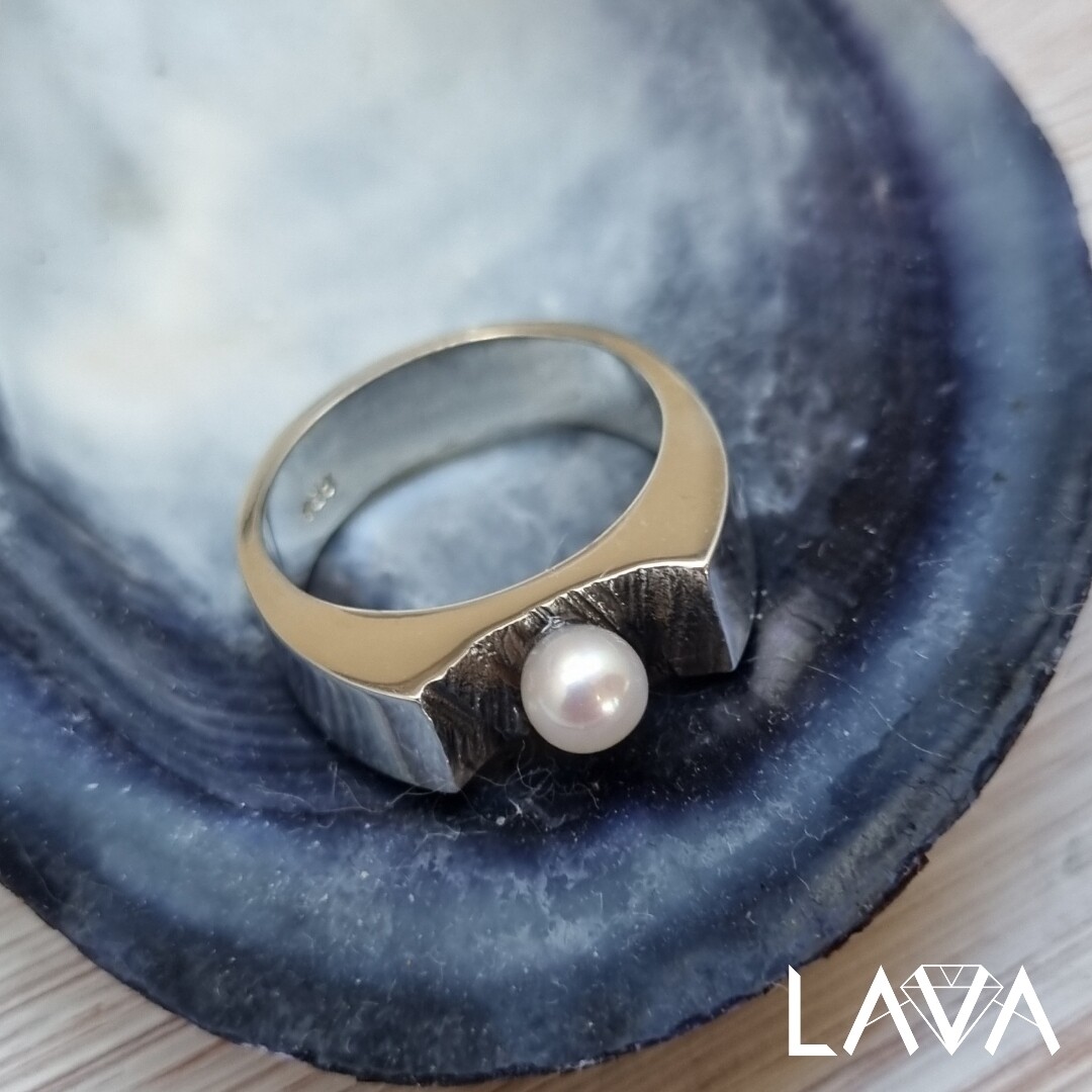Pearl ring on rocky surface