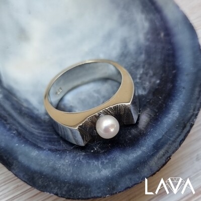 Pearl ring on rocky surface