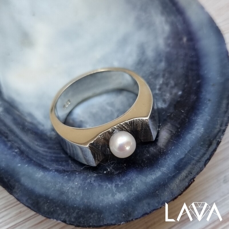 Pearl ring on rocky surface