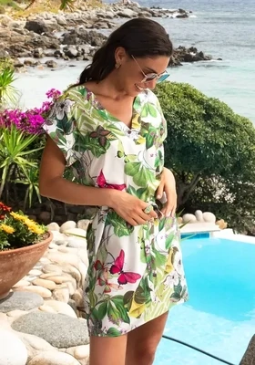Lise Charmel Envolee Tropicale Tunic Sundress. The leafy abstract print features foliage and the occasional butterfly. Model shown by the pool.