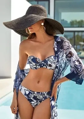 Roidal Arlet Bandeau bikini. The underwired bikini top has removable straps. The fabric is 'paisley' print, in an attractive navy blue and white colourway. Lifestyle photo.