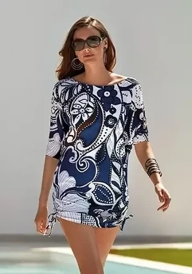 Roidal Cachemire Gina Complice Dress. Stylish Blue and White Paisley print. The dress length falls above knee level, and has side ties allowing you to raise or drop the hemline. Lifestyle photo.