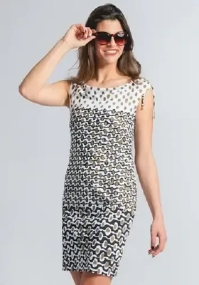 Roidal Noa Leila Complice Dress. Abstract Brown, Black and White "dot and wave" print. The hemline is just above the knee. Golden tipped drawstrings at the shoulder can give a rise or fall effect, and the dress can be worn on or slightly off the shoulder.