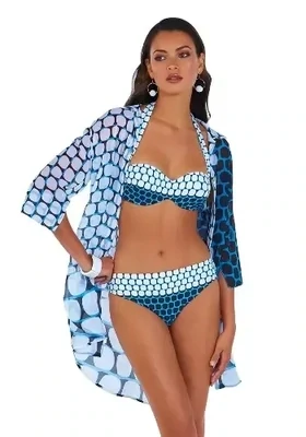 Roidal Bicolour Blue Aurea D cup Bikini. The fabric is a geometric print in Blue and White. A removable halterneck strap lets you create two looks from the one bikini. Tailored foam lined D cups combine with the underwires to give full support. Shown with matching shirt dress.