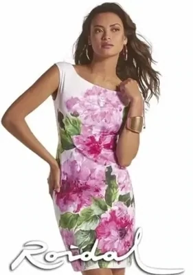 Roidal Larys Danae Complice Dress. Pink floral design on a White background. The golden tipped drawstrings at the shoulder can give a rise or fall effect.