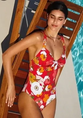 Lilia Bow Front Swimsuit by Nuria Ferrer. The fabric is a floral print on a red background. Lifestyle photo.