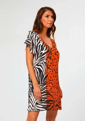 Nairobi Dress by Nuria Ferrer. The fabric is a deep orange, black and white stylised animal print. Lifestyle photo.