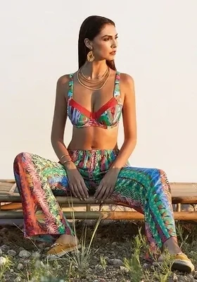 Ceylan Caribbean Beach Trousers by Nuria Ferrer. The fabric is a colourful tropical print. Lifestyle photo.