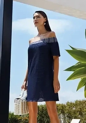 Capri Sundress by Nuria Ferrer. The beach cover up is a navy blue cloth with a white trim neck. Lifestyle photo.