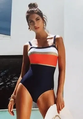 Layla Swimsuit by Nuria Ferrer in a blue, coral, white and gold pattern. Lifestyle photo.