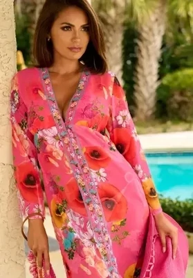 Copacabana Maxi Kaftan Dress, a maxi length pink floral print beach cover up. Lifestyle photo.