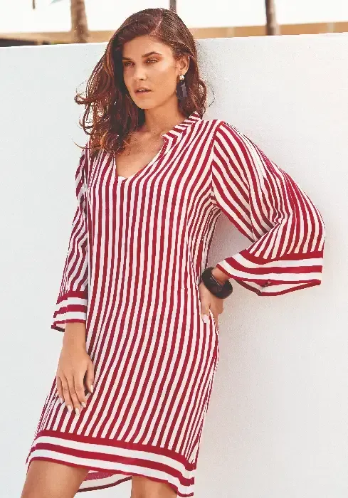 David Swimwear Capri Sleeved Dress in a Red and White striped fabric. Lifestyle photo.