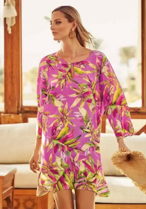 Pink Heart Tunic Dress by Charmline. The fabric features an abstract watercolour style foliage print against a pretty pink background. Lifestyle photo.