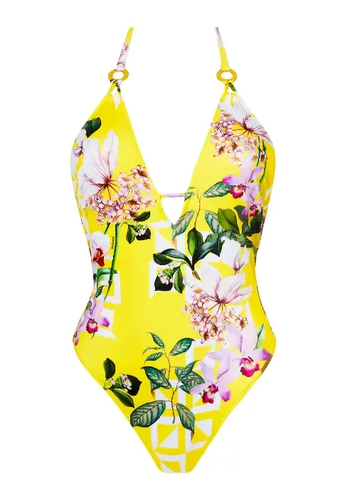 Lise Charmel Jardin Delice Swimsuit with deep V neckline in a floral print on  a yellow background. Lisestyle photo.