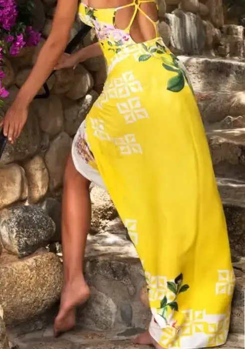 Lise Charmel Jardin Delice Soleil Pareo. The fabric is a floral print on a yellow background. Lifestyle photo.