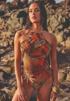 Lifestyle shot of the  David Paradise Island Zamira Swimsuit in a stylised foliage print in warm spice island autumnal shades