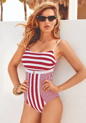 Capri Cherry Red Swimsuit by David Swimwear in a Red and White striped design with gold coloured embellishments. Lifestyle photo.