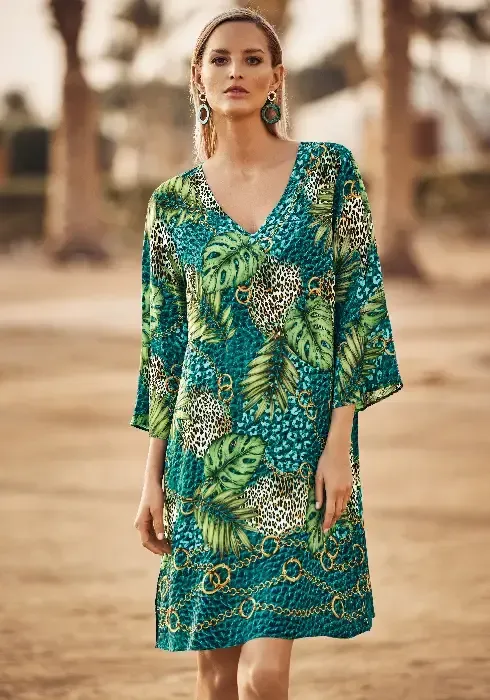 Jungle Jewels Kaftan Tunic by Charmline.  Featuring a beautiful design with exotic leaves, animal prints and a meandering gold chain print. Lifestyle photo.