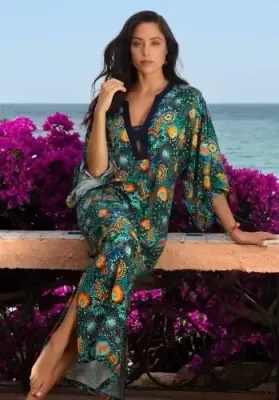 Lise Charmel Beaute Cosmique Long ankle length Kaftan with intricate  “Beautiful Cosmic Sky” print reminiscent of the sophisticated details in paintings by Klimt. Lifestyle photo.