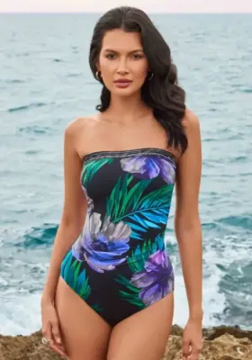 Flora Aura Avanti Swimsuit by Miraclesuit. A bandeau swimsuit in a multicoloured floral print fabric. Lifestyle photo.