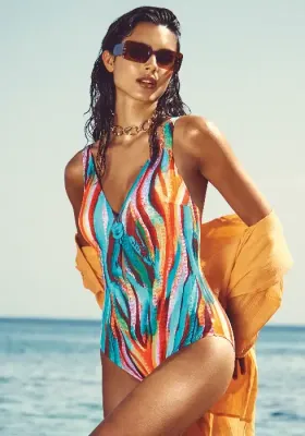 Aquarelle V-neck Swimsuit Nuria Ferrer Aquarelle V-neck Swimsuit. It features a bright modern print of stylised flowers and colourful swirls. Lifestyle photo