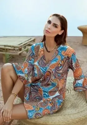Venus Kaftan Dress by Nuria Ferrer. The fabric is a blue paisley print. Lifestyle photo.